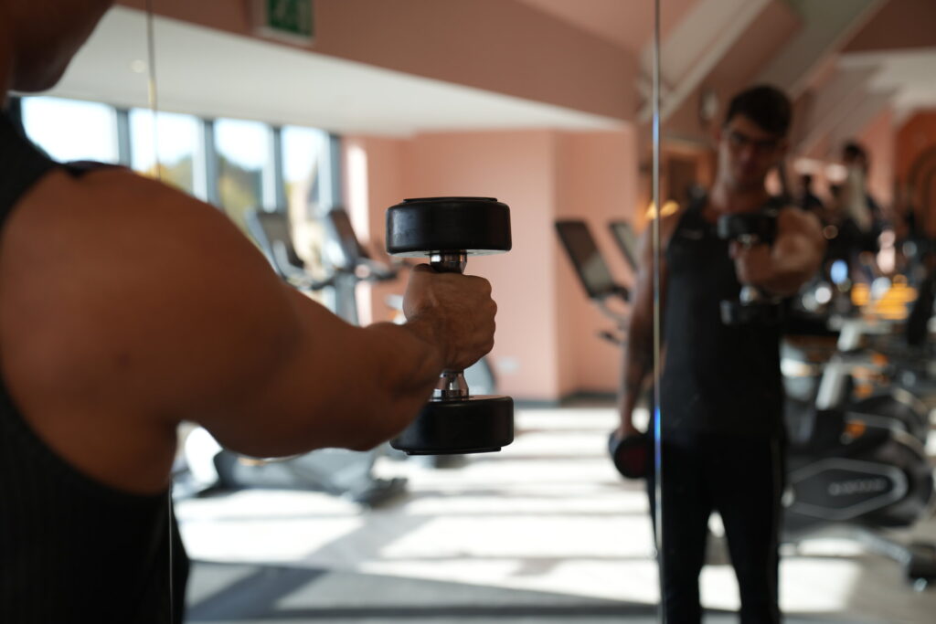 gym member with dumbbells