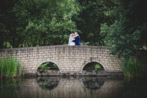 Bride and groom on bridge