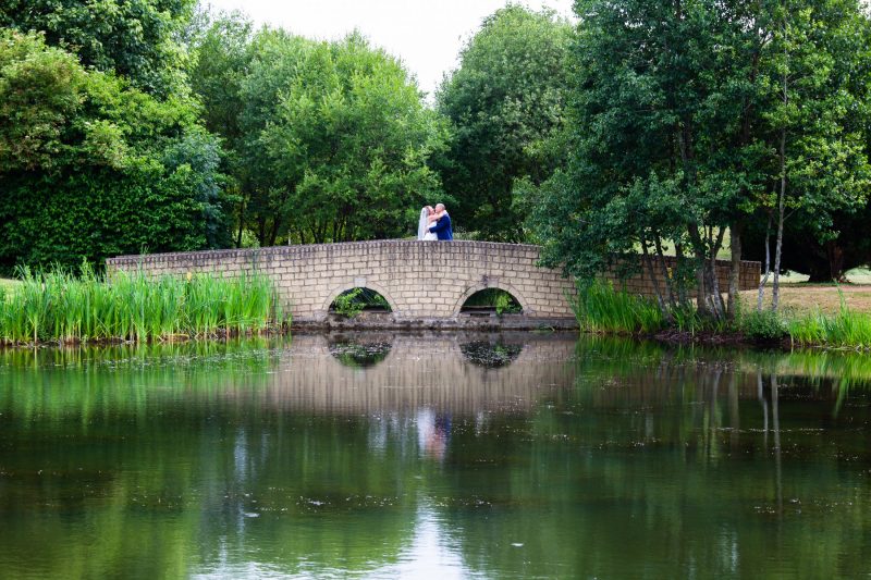 Bride and groom on bridge