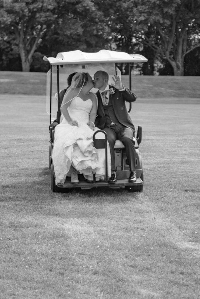 Bride and groom on golf cart