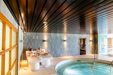 Spa guests laying next to pool