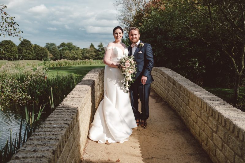 Bride and groom on bridge
