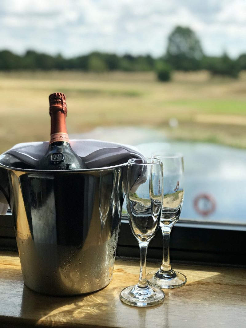Champagne bottle in bucket and glasses